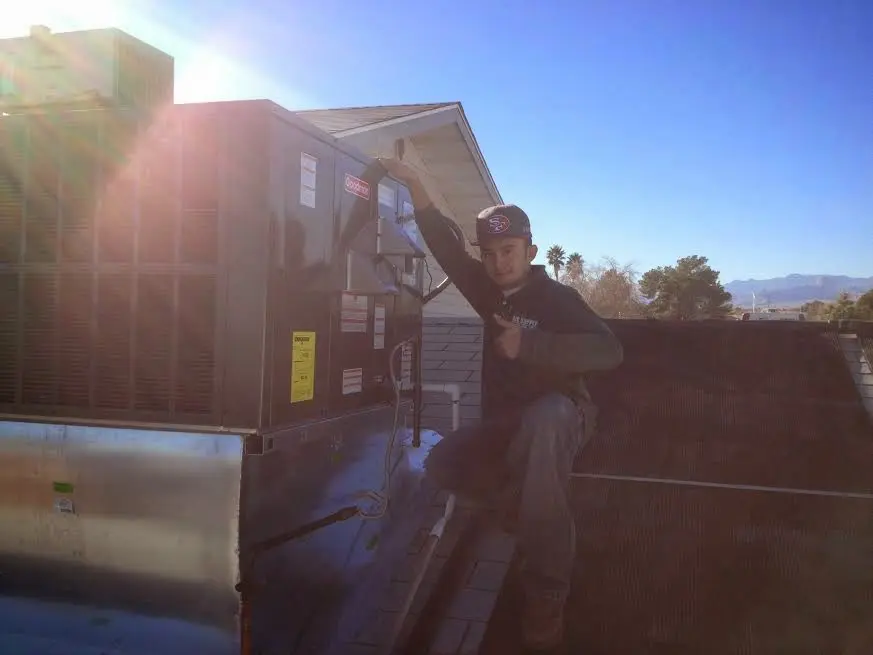 HVAC technician performing AC Tune-Up on a rooftop unit in Camp Pendleton Mainside